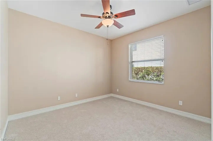 Empty room featuring carpet and ceiling fan