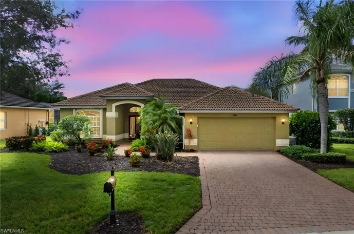 Mediterranean / spanish-style home featuring stucco siding, a garage, and a lawn