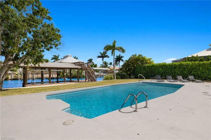 Pool view with canal and boat house