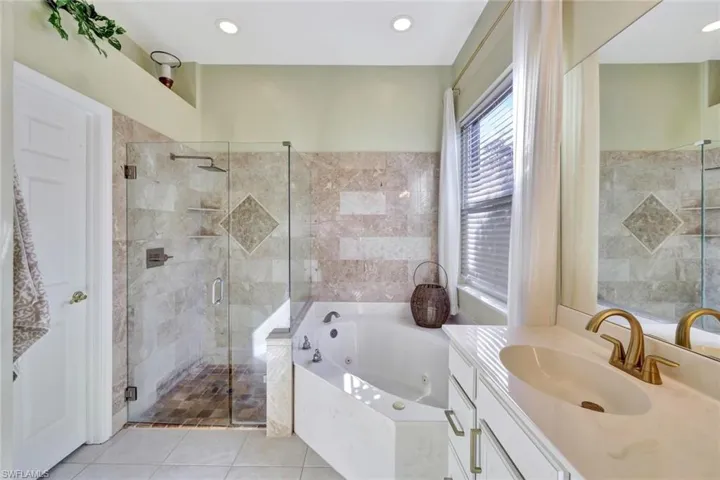 Soaking tub and frameless shower.