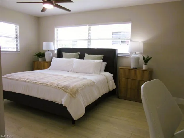 Bedroom featuring multiple windows and light hardwood / wood-style floors