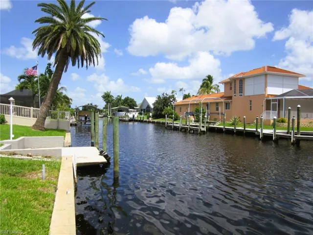 View of dock featuring glass enclosure and a water view