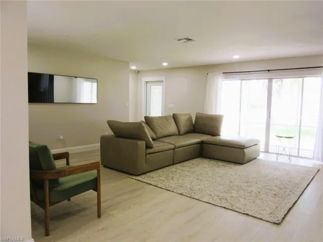 Living room with light hardwood / wood-style flooring