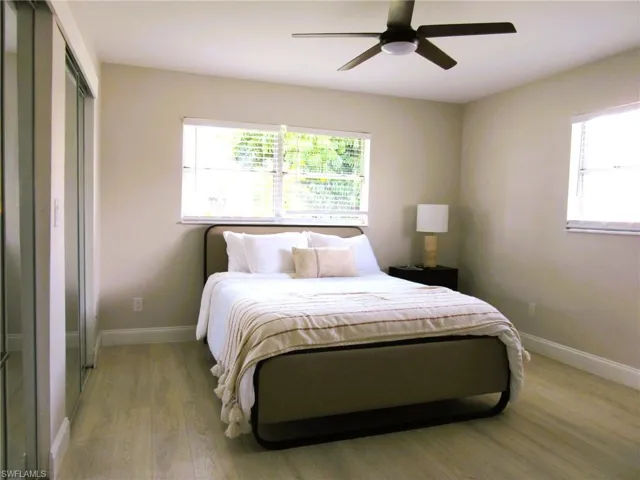 Bedroom with a closet, ceiling fan, and light hardwood / wood-style floors