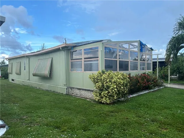 View of side of home with a lawn