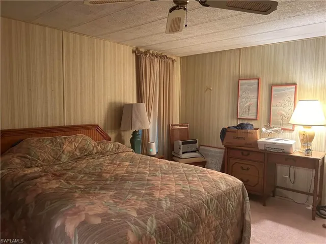 Carpeted bedroom with ceiling fan