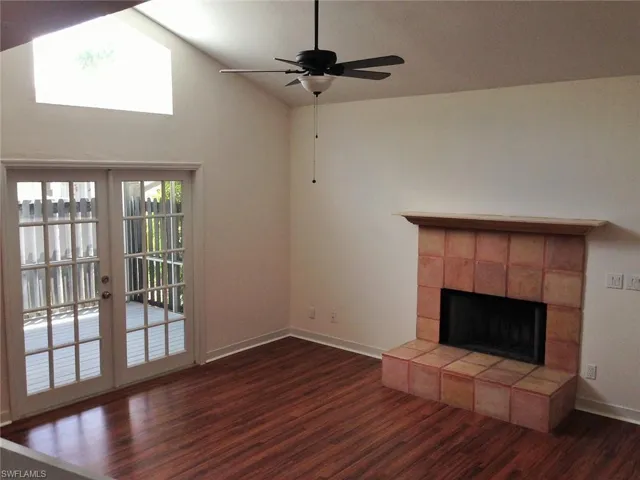 High ceilings, large windows & an electric fireplace create a charming home