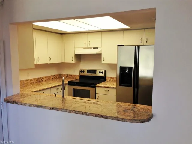 Kitchen has granite counters and newer appliances