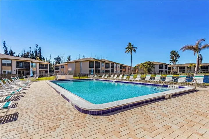 Community pool with a residential view and a patio