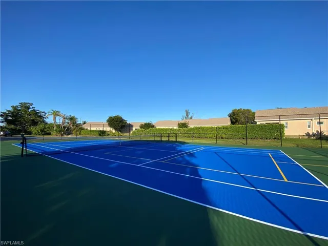 View of tennis court with community basketball court