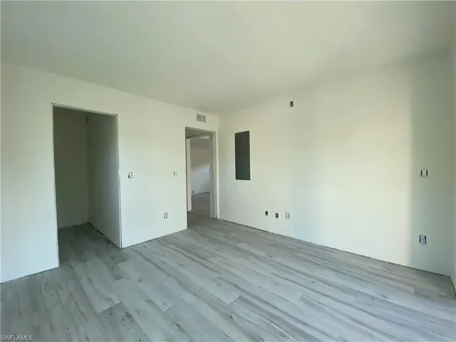 Spare room featuring light wood-style flooring and electric panel