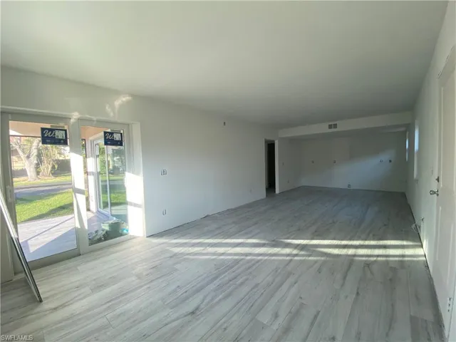 Unfurnished living room with wood finished floors