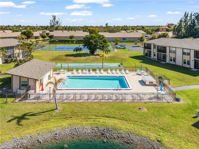 Community pool with a patio and a residential view