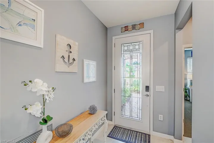 Doorway featuring light tile patterned floors