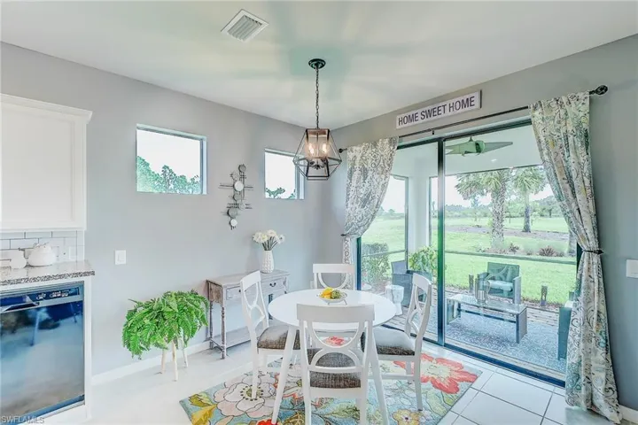 Dining room featuring light tile patterned flooring and an inviting chandelier