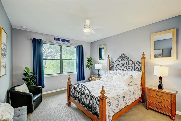 Carpeted bedroom with ceiling fan