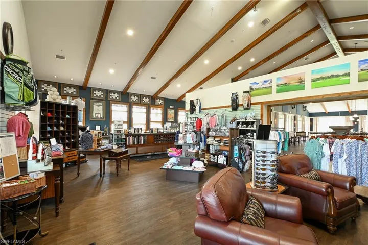 Living room with hardwood / wood-style floors, beam ceiling, and high vaulted ceiling