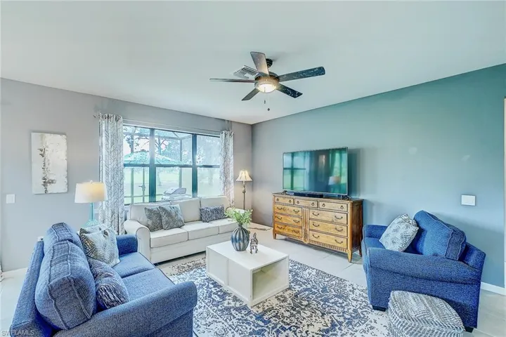 Living room featuring ceiling fan and light tile patterned floors