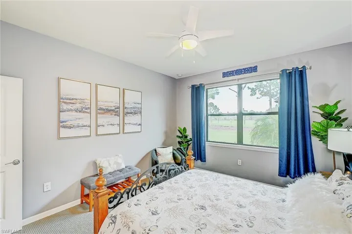 Carpeted bedroom with ceiling fan
