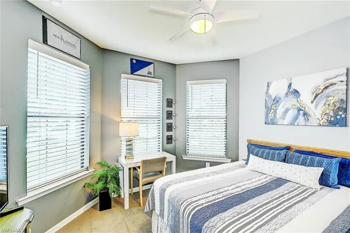 Bedroom with light colored carpet and ceiling fan
