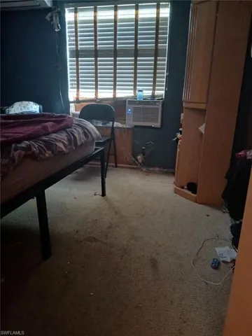 Bedroom featuring carpet floors and cooling unit