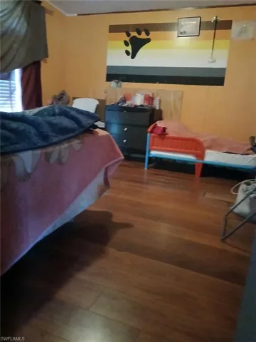 Bedroom with wood-type flooring