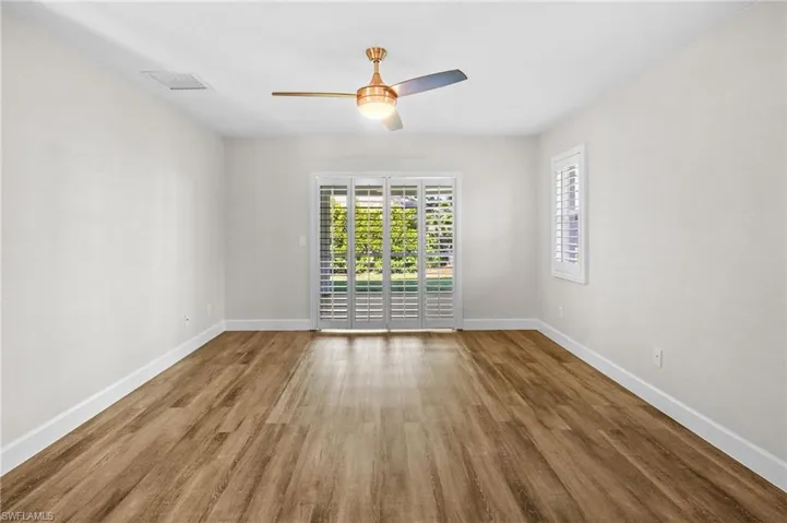 Empty room with wood finished floors and ceiling fan