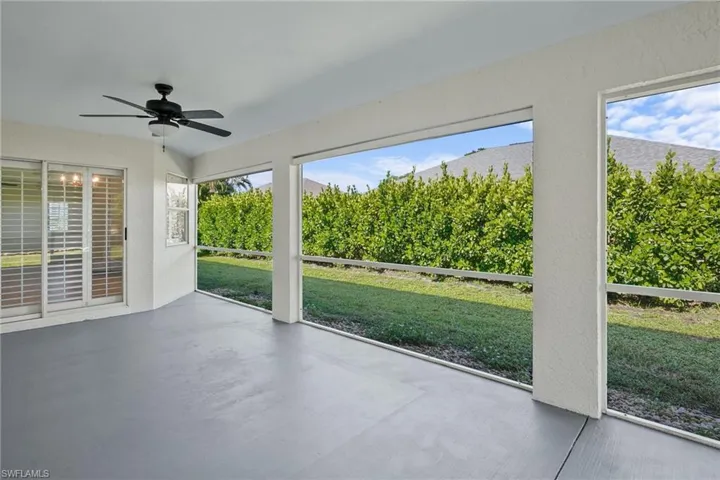 Unfurnished sunroom featuring a ceiling fan
