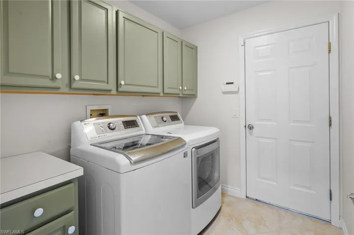 Laundry area featuring cabinet space and independent washer and dryer