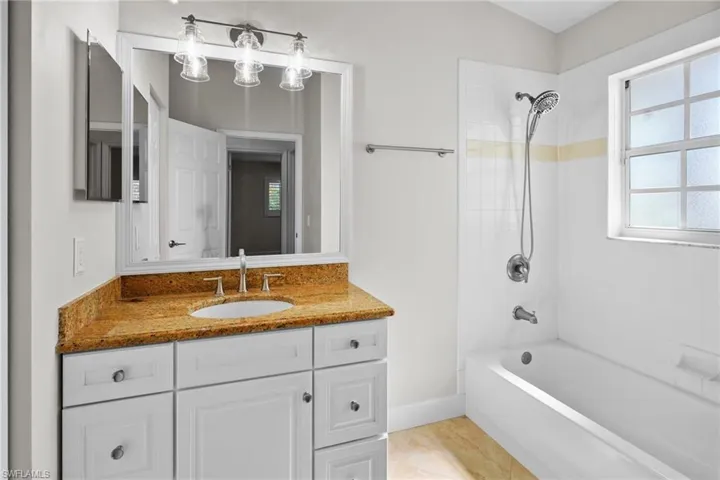 Full bathroom featuring vanity and  shower combination