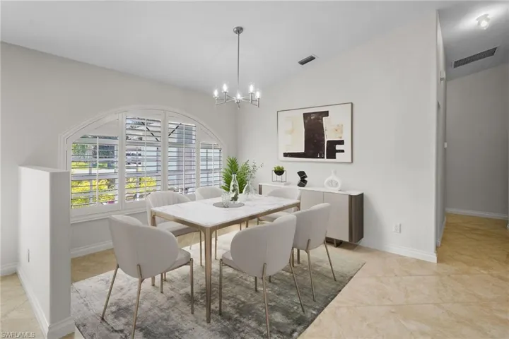 Dining room featuring lofted ceiling and a chandelier