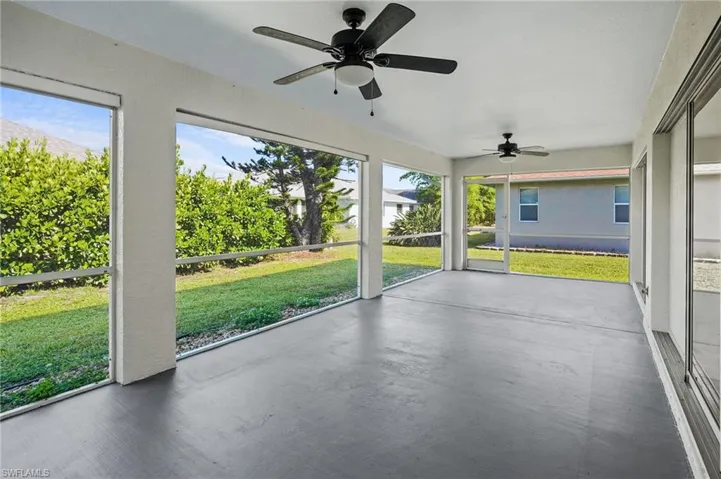 Unfurnished sunroom with ceiling fan
