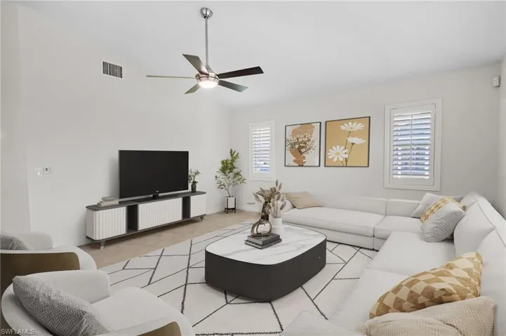 Living room with vaulted ceiling and a ceiling fan