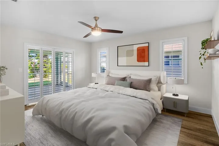 Bedroom with access to outside, wood finished floors, and a ceiling fan