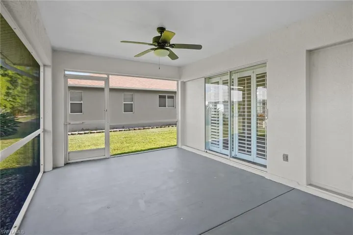 Unfurnished sunroom with ceiling fan
