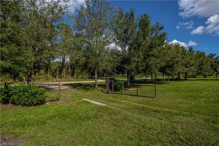 View of property's community featuring a lawn and a rural view