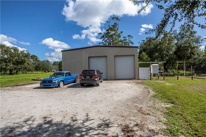 Garage featuring a lawn