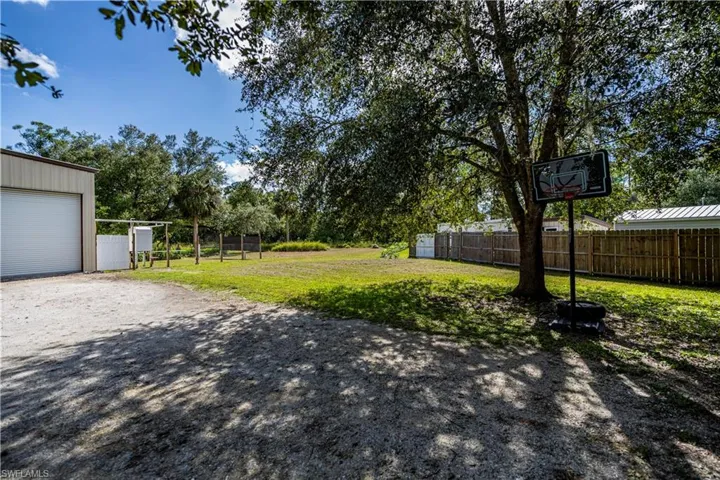 View of yard featuring a garage and an outdoor structure