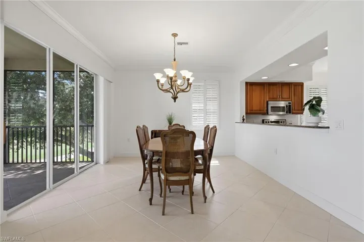 Dining Room with Golf Course ViewsA bright, spacious dining area offering seamless access to the screened lanai, an open connection to the kitchen, and peaceful golf course views—perfect for entertaining and everyday dining.