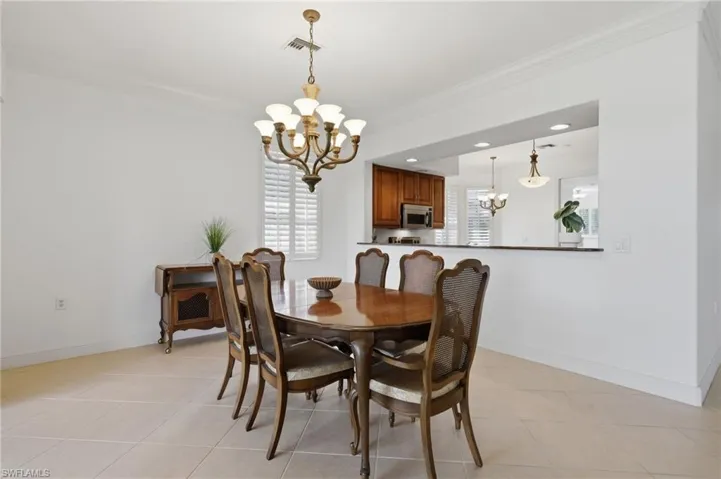 Dining Room with Golf Course ViewsA bright, spacious dining area offering seamless access to the screened lanai, an open connection to the kitchen, and peaceful golf course views—perfect for entertaining and everyday dining.