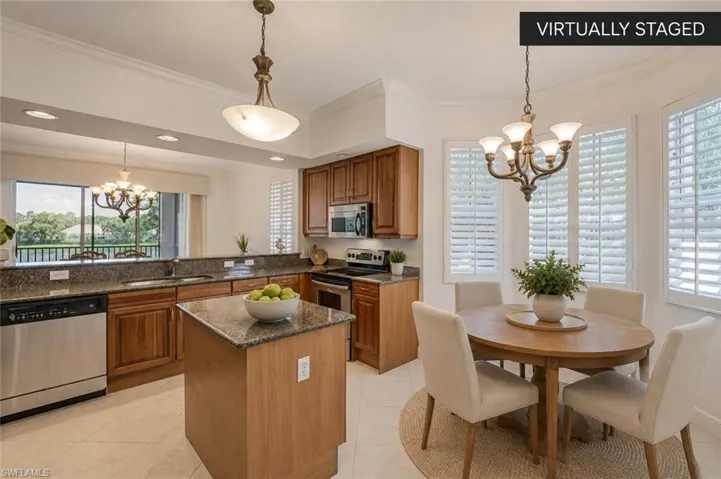 Bright Kitchen with Breakfast Nook & Golf ViewsGranite countertops, abundant cabinetry, a center island, plantation shutters, and a light-filled breakfast nook create the perfect gathering space while offering beautiful golf course and lake views. (Virtually staged.)