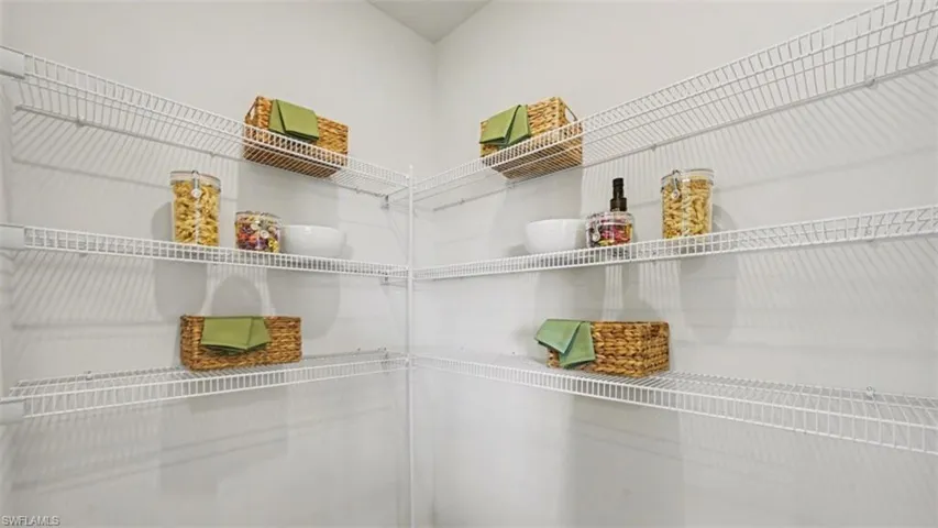 Corner pantry with multiple levels of white wire shelving