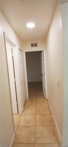 Hall with light tile patterned flooring