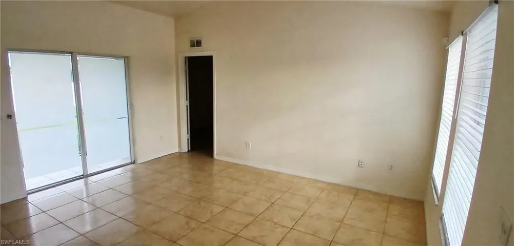 Unfurnished bedroom featuring light tile patterned floors and a closet