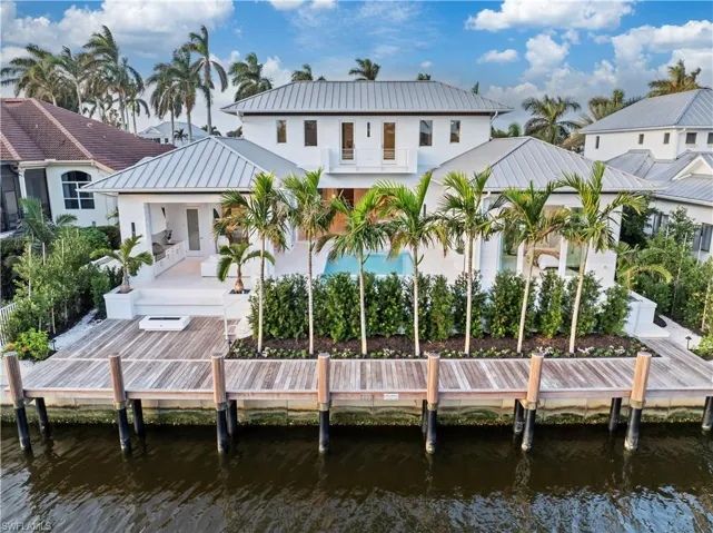 Rear view of property with a balcony and a water view