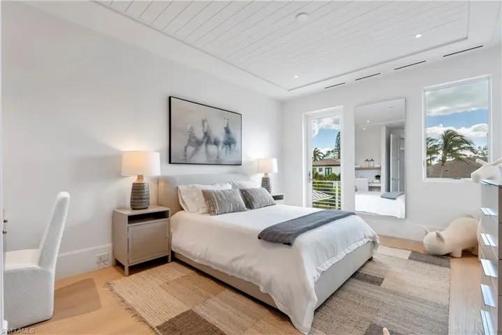 Bedroom featuring wooden ceiling and light hardwood / wood-style flooring