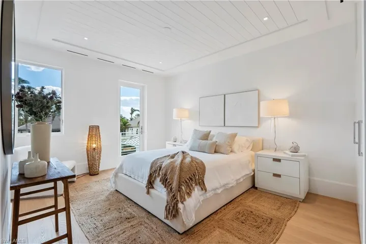 Bedroom with light wood-type flooring and wood ceiling