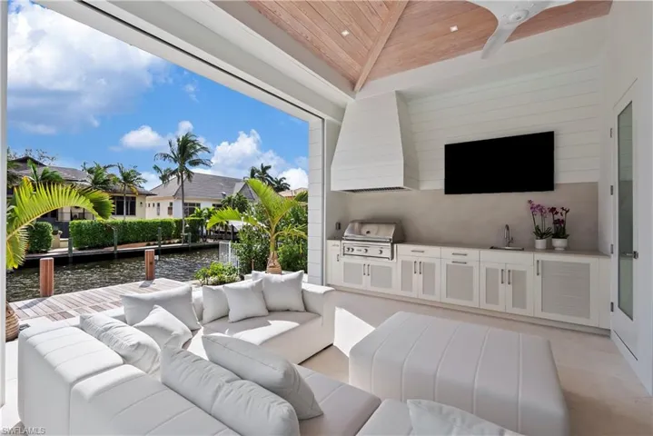 View of patio featuring an outdoor living space, area for grilling, sink, and ceiling fan