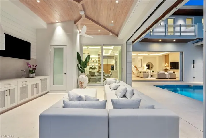 Patio with ceiling fan, sink, high vaulted ceiling, and wood ceiling