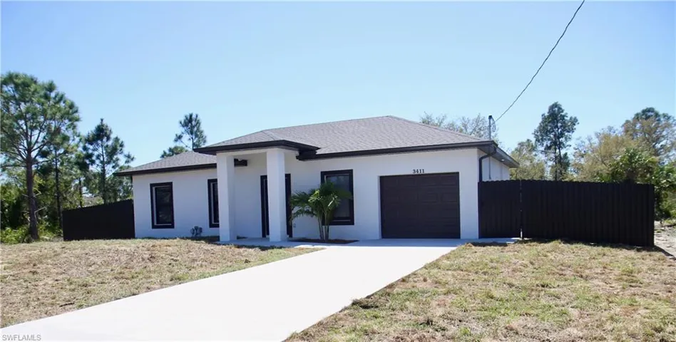 View of front of property with roof with shingles, stucco siding, concrete driveway, an attached garage, and fence